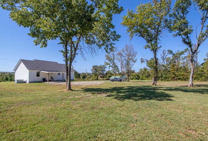 View of grassy yard with a patio area