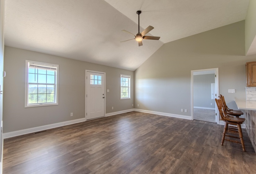 Entryway with high vaulted ceiling, ceiling fan, and dark wood finished floors