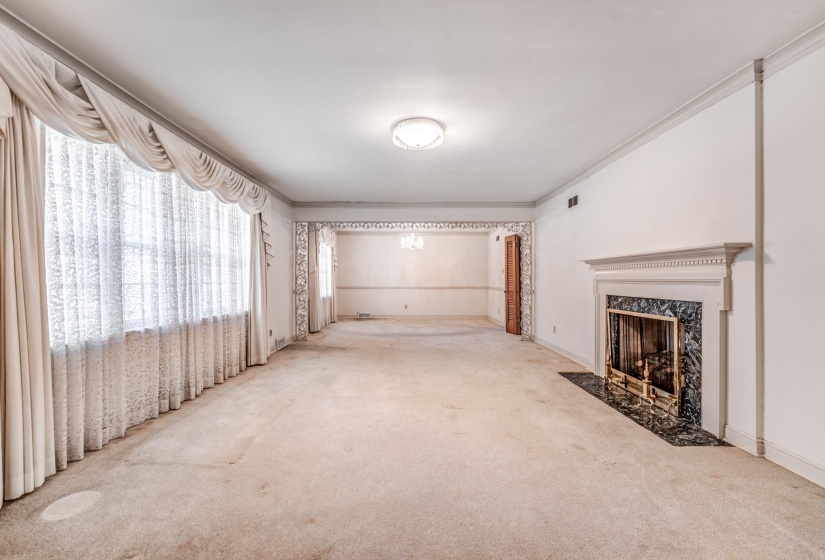 Corridor with carpet flooring, ornamental molding, and a chandelier