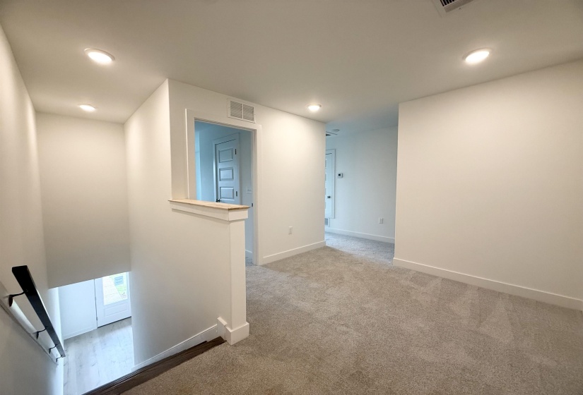 Hallway featuring recessed lighting, carpet flooring, and an upstairs landing