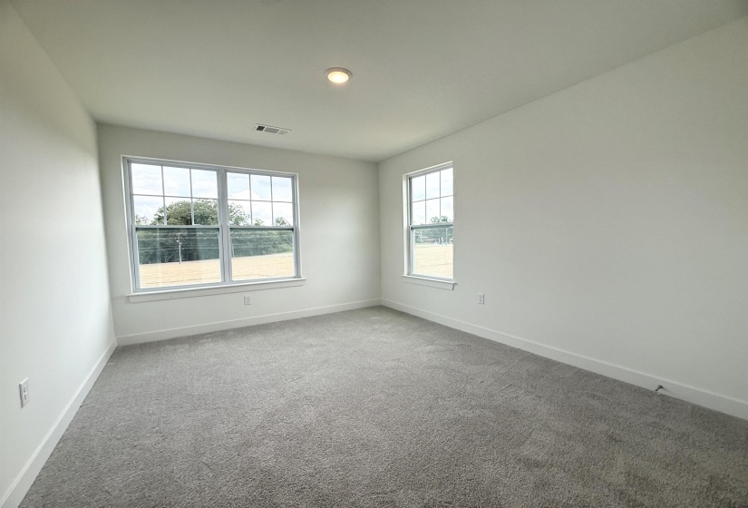 Carpeted empty room featuring baseboards