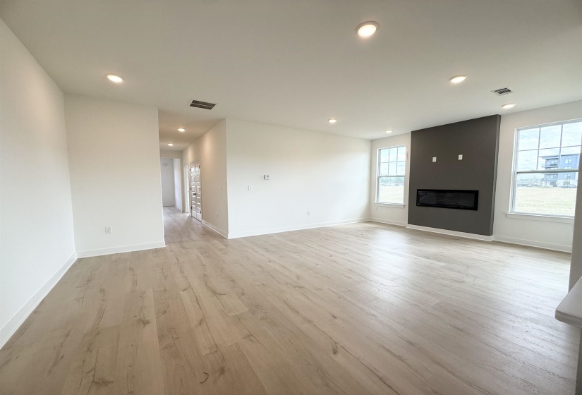 Unfurnished living room with recessed lighting, light wood-style flooring, and a fireplace