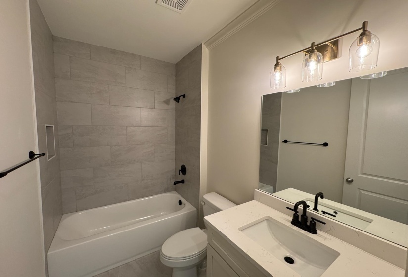 Full bath featuring vanity and bathing tub / shower combination