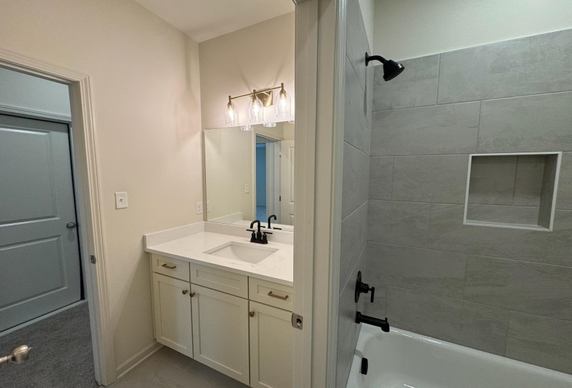 Bathroom with vanity and washtub / shower combination