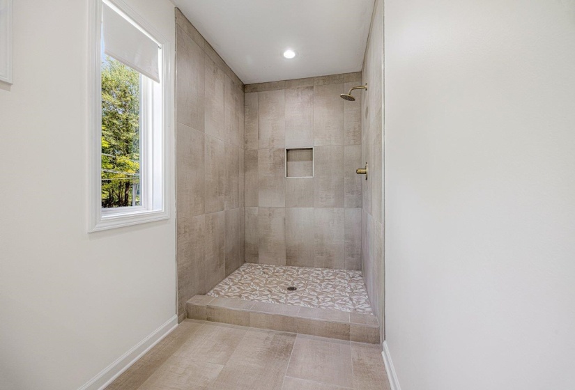 Bathroom featuring a tile shower and recessed lighting
