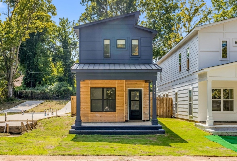 Rear view of property with a metal roof, a standing seam roof, and covered porch