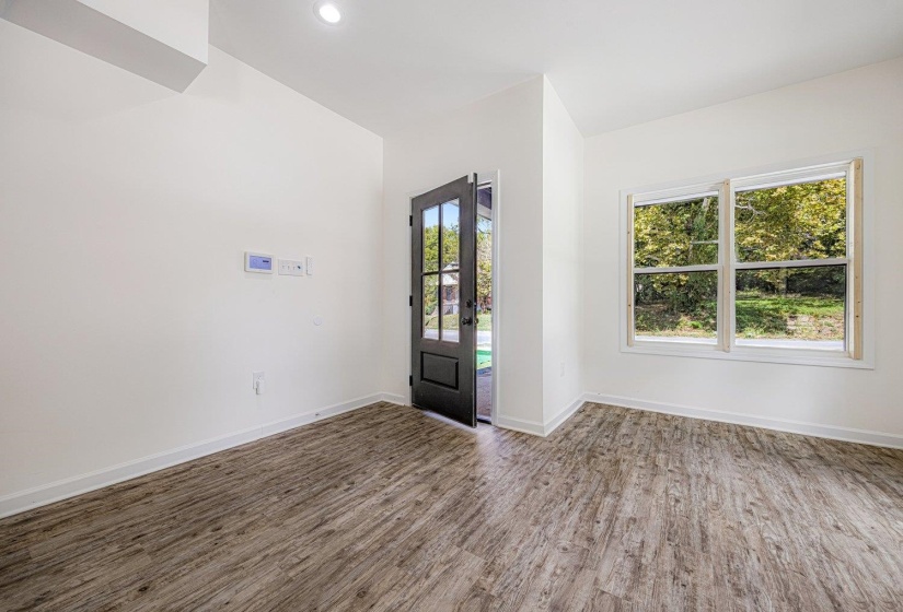 Entrance foyer with wood finished floors, recessed lighting, and french doors