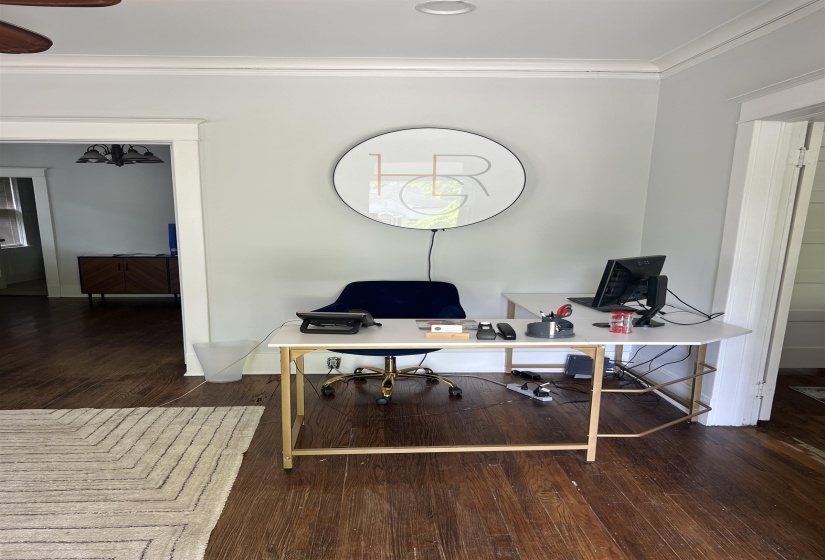 Home office featuring crown molding and dark wood finished floors