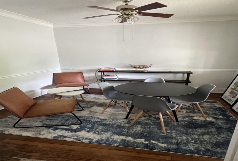 Dining space featuring crown molding, dark wood-type flooring, and a textured ceiling