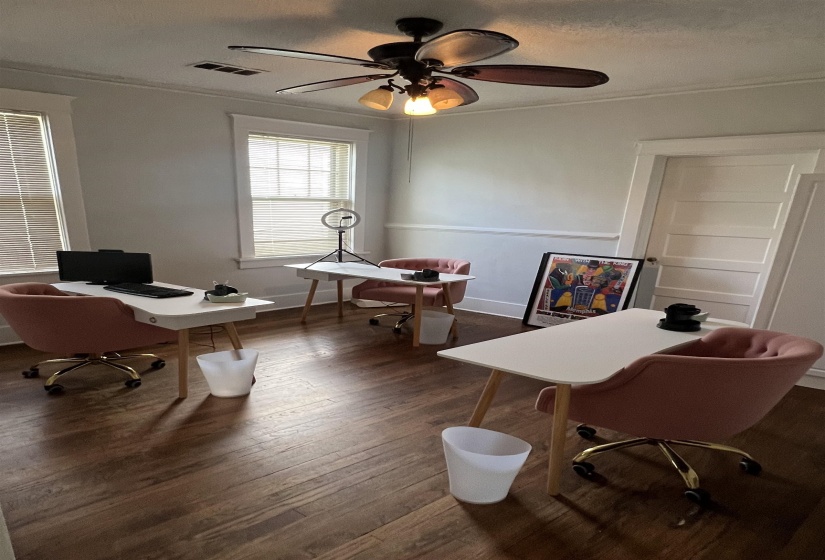 Office space with ornamental molding, wood finished floors, a ceiling fan, and a textured ceiling