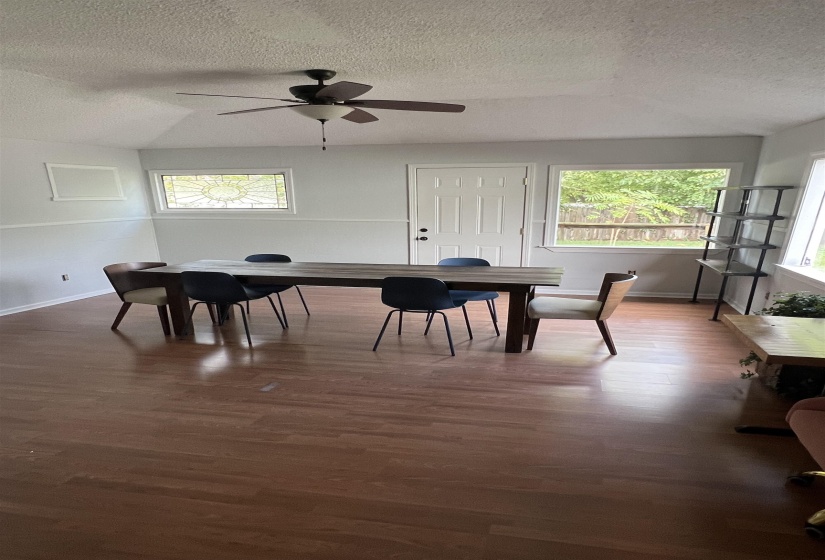 Dining area featuring a textured ceiling, wood finished floors, and a ceiling fan