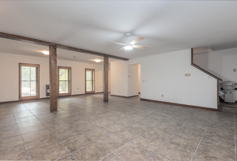 Spare room featuring a ceiling fan and beamed ceiling