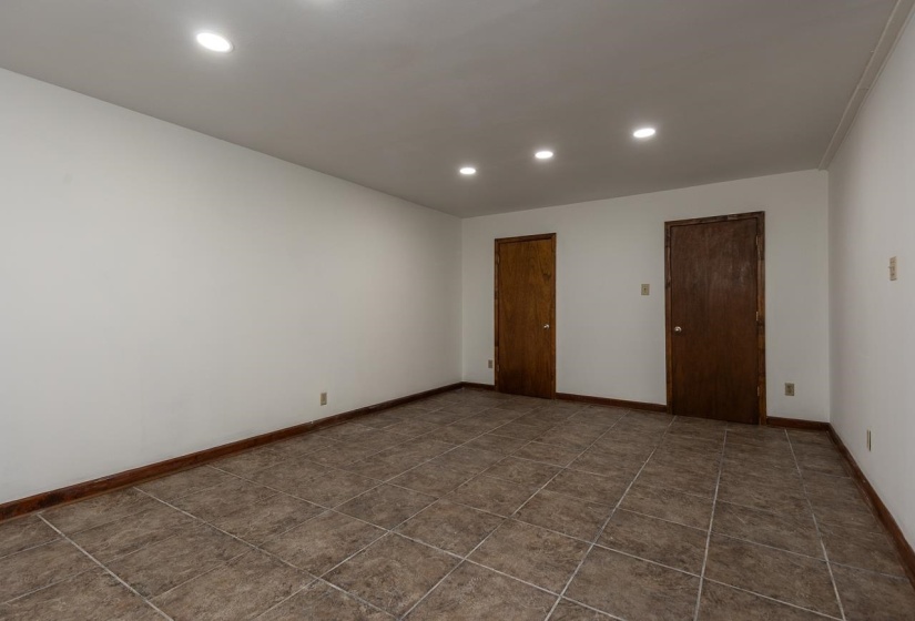 Room with 2 closets connected to the kitchen area in basement.  Cannot legally be called a bedroom because this room has no window - but if you don't close the door the connecting room does have a window.