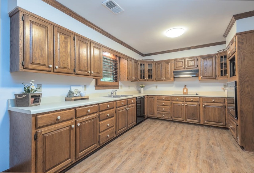 Large open kitchen with wood flooring, fresh paint, pantry and lots of counter space.