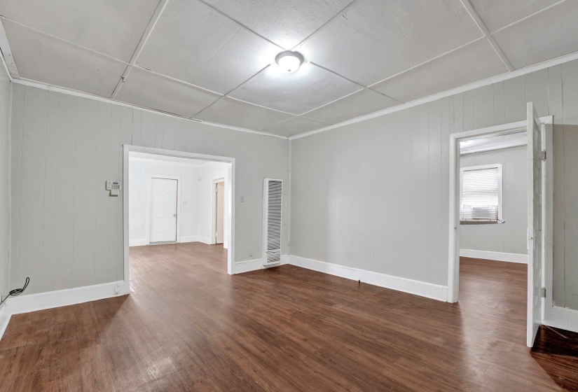 Unfurnished room with wood finished floors and baseboards
