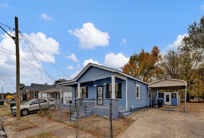 View of front of property featuring a gate, fence, driveway, a porch, and a carport