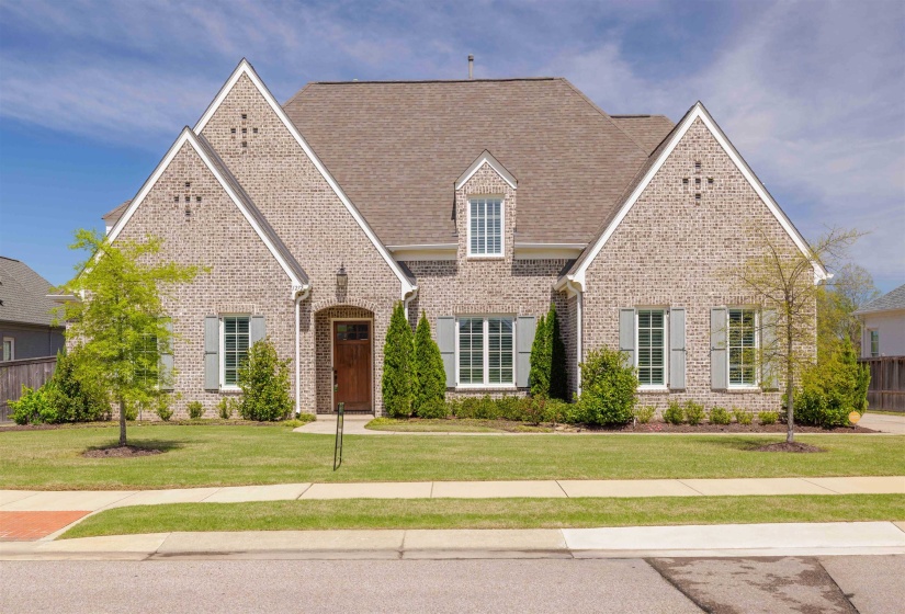 Tudor house with brick siding and roof with shingles