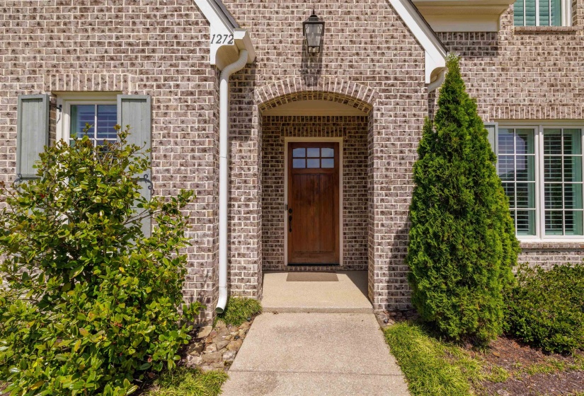 Doorway to property featuring brick siding