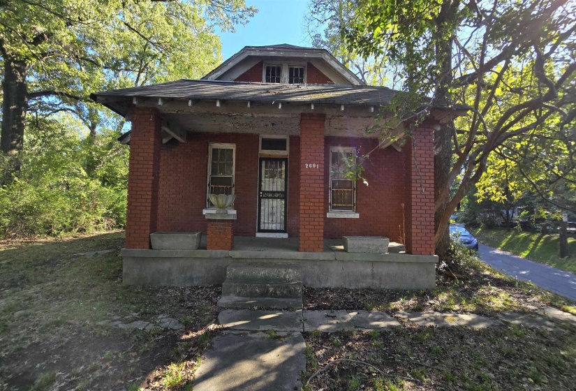 View of front of property featuring a porch and brick siding