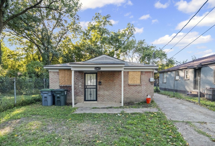 Rear view of property with brick siding