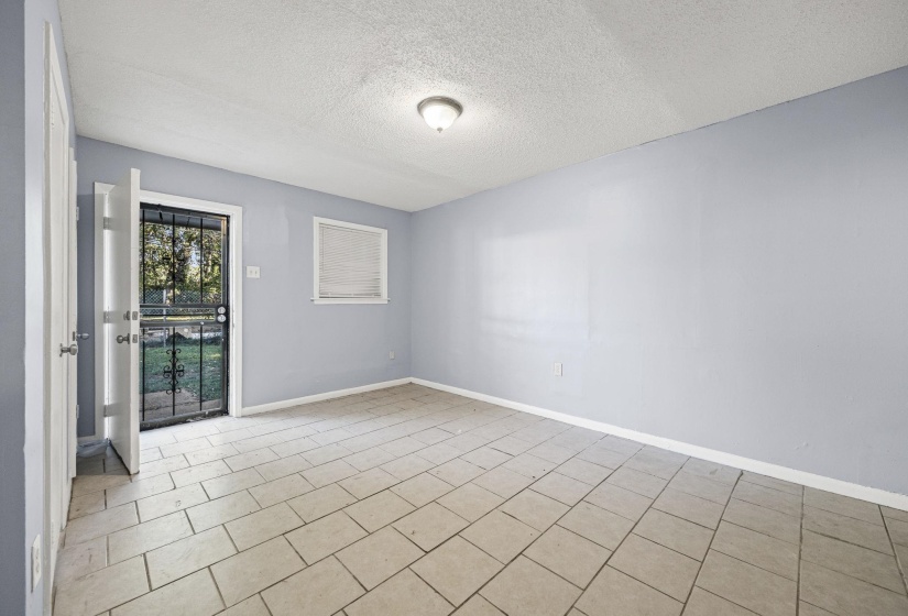 Unfurnished room featuring a textured ceiling and light tile patterned floors