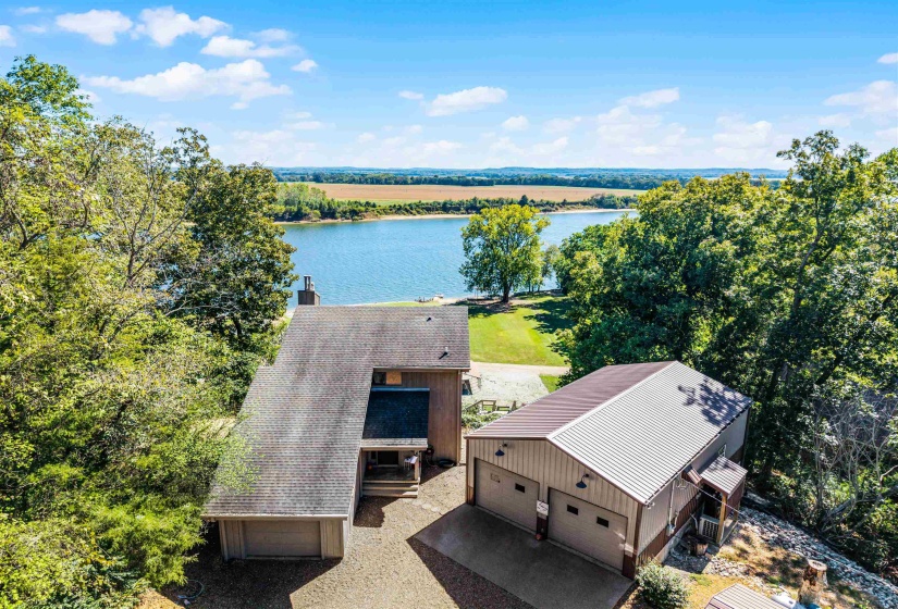 Aerial view of property and surrounding area with a nearby body of water