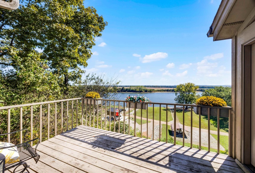 Wooden deck featuring a yard and a water view