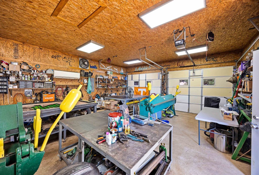 Garage with a garage door opener and a wall unit AC