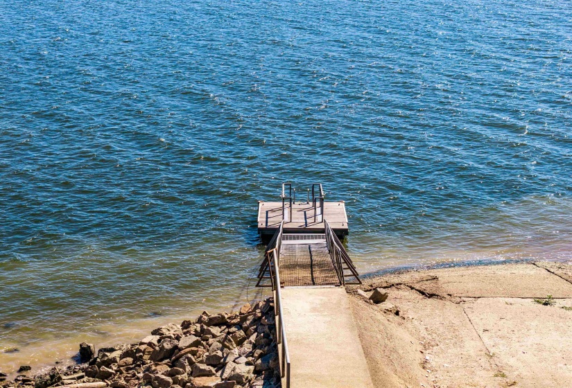 Dock area featuring view of water and beach