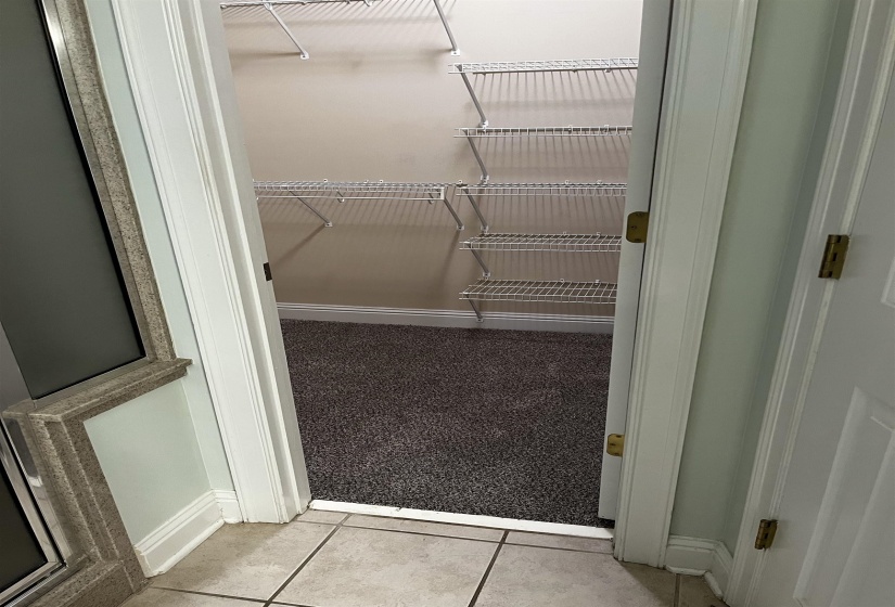 Walk in closet featuring light tile patterned flooring