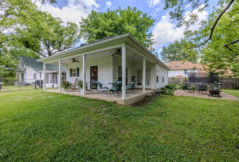 Back of property with an outdoor fire pit, a ceiling fan, and a patio