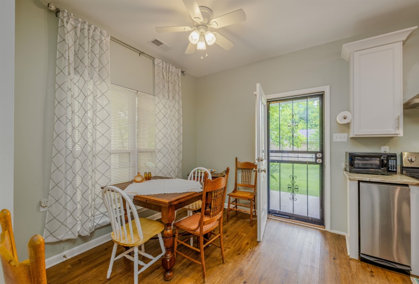 Dining space featuring light wood-type flooring, ceiling fan, and baseboards