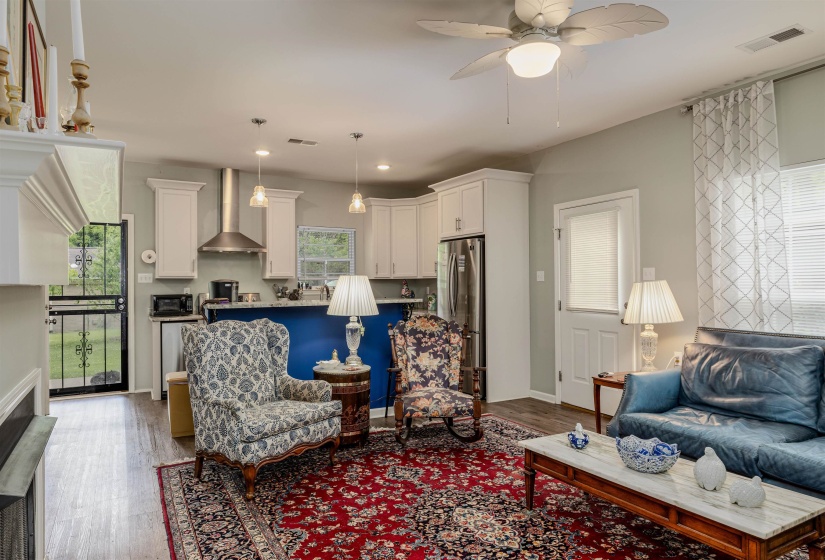 Living room featuring light wood-style flooring, ceiling fan, recessed lighting, and baseboards