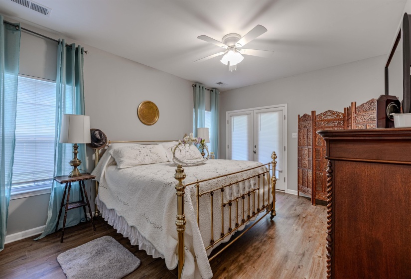 Bedroom featuring wood finished floors, a ceiling fan, and baseboards