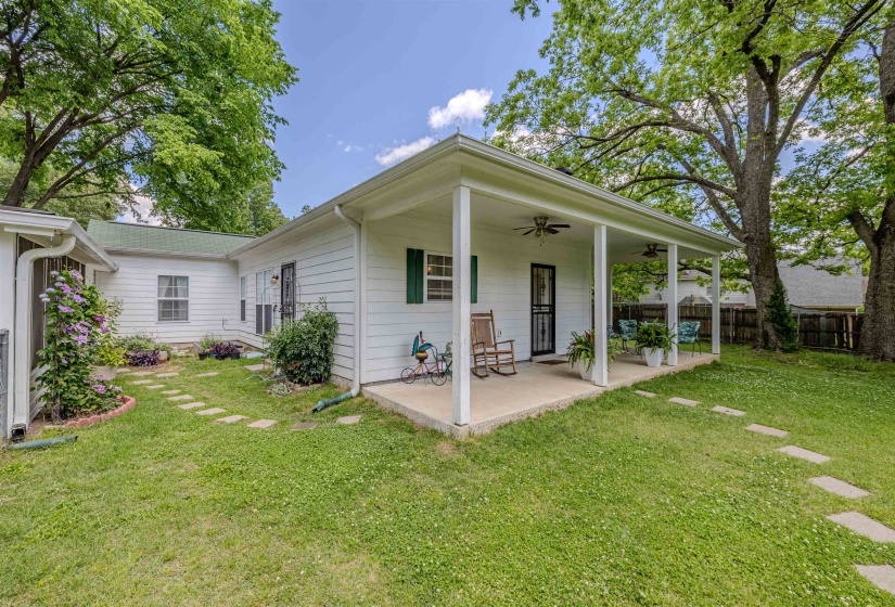 Back of property with ceiling fan and a patio area
