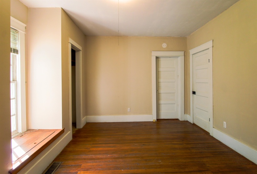 Bedroom featuring original hardwood floors and two closets
