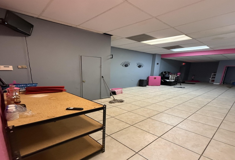 Interior space featuring a drop ceiling and light tile patterned flooring