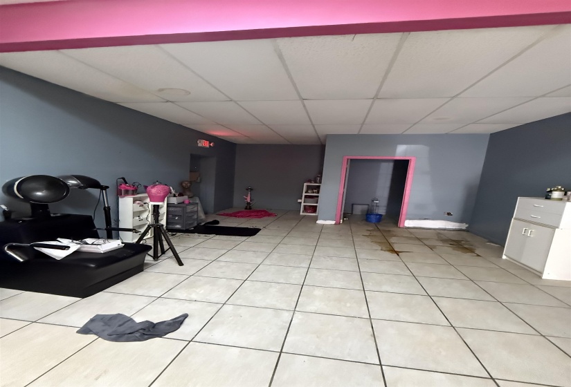 Exercise area with a drop ceiling and light tile patterned floors