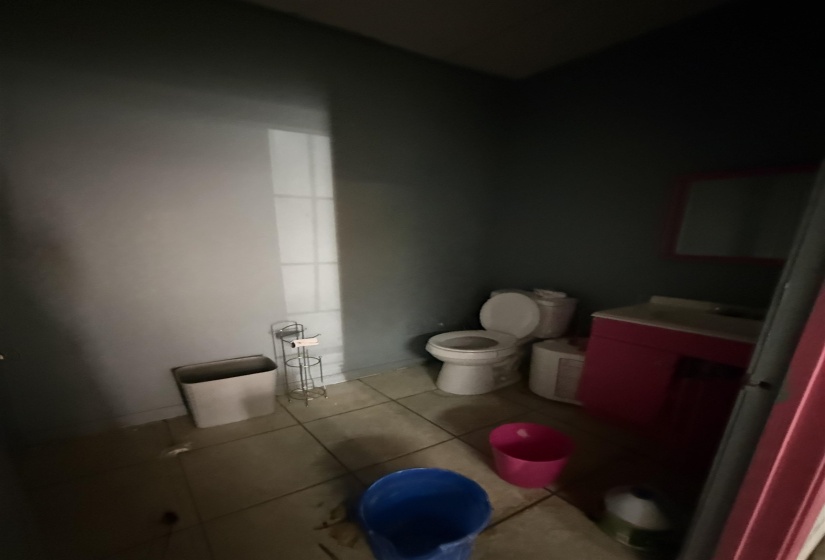 Half bathroom with vanity and tile patterned floors