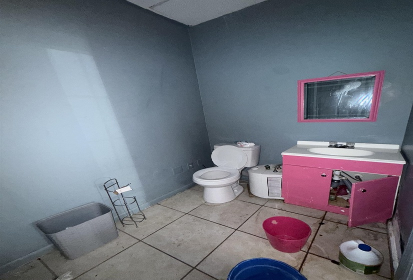 Half bath with vanity and tile patterned floors
