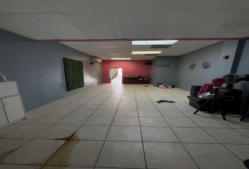 Below grade area with a paneled ceiling and light tile patterned floors