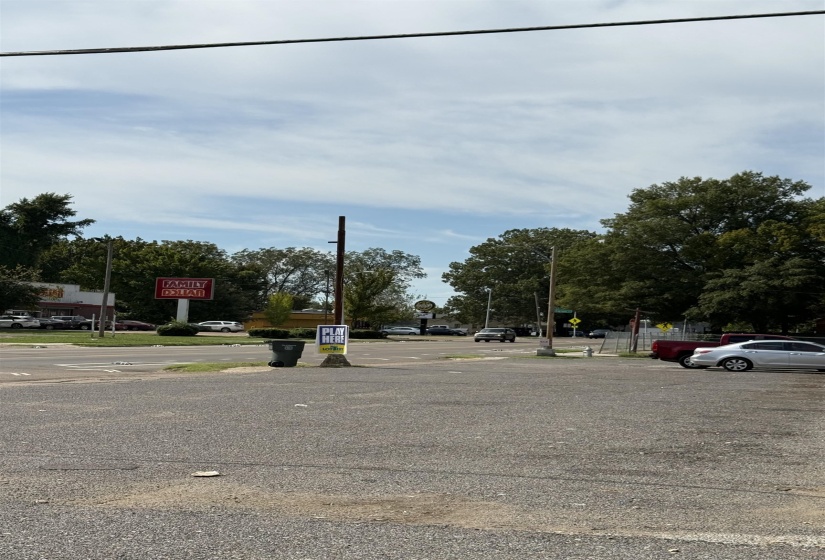 View of asphalt street featuring traffic signs