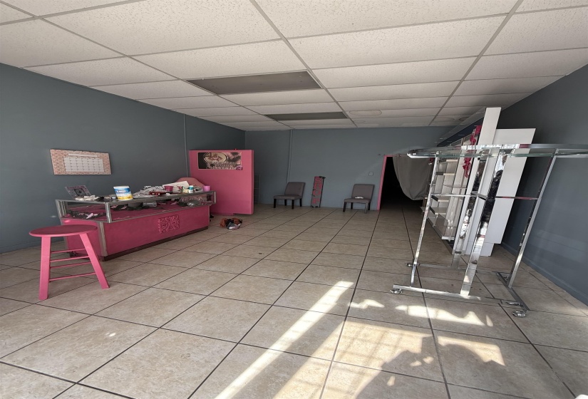 Interior space featuring a paneled ceiling and light tile patterned floors