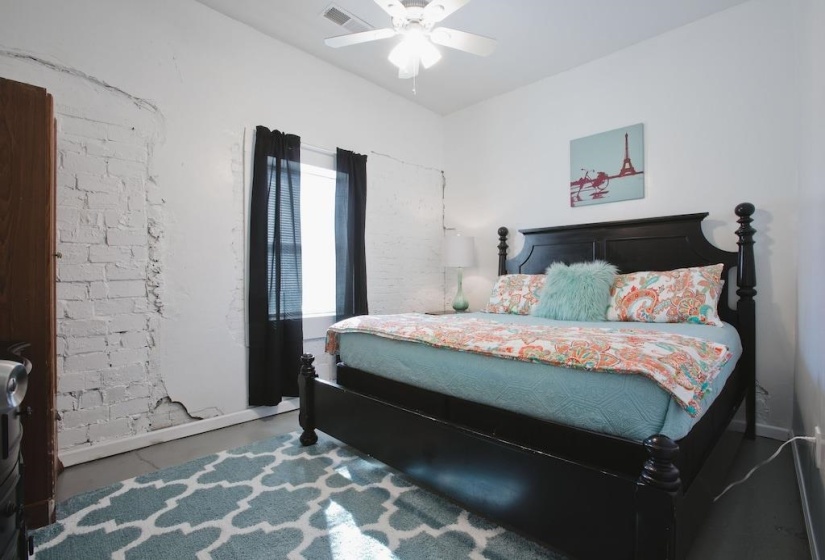 Bedroom with a ceiling fan and baseboards