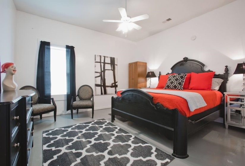 Bedroom featuring finished concrete flooring and ceiling fan