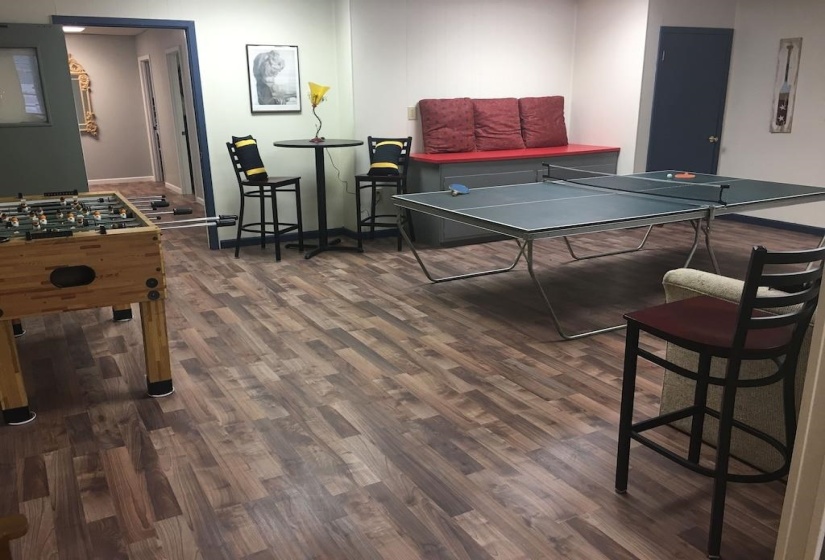 Rec room featuring dark wood-style flooring and baseboards
