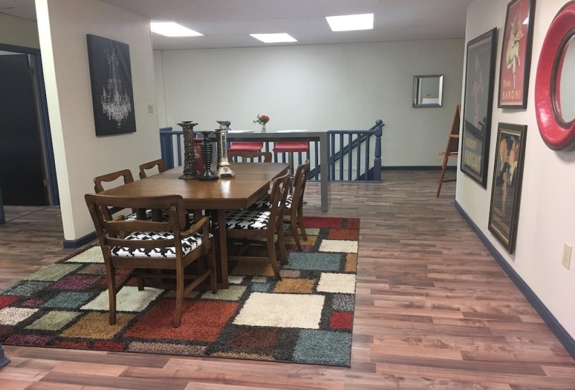Dining area featuring dark wood-style flooring and a paneled ceiling