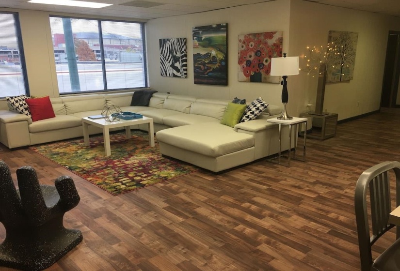 Living room featuring dark wood-style floors and a drop ceiling