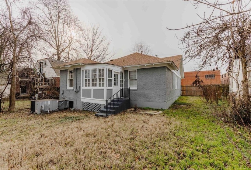 Back of property with a yard