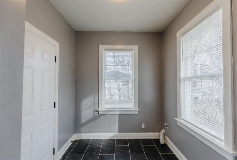 Unfurnished room featuring dark tile patterned floors